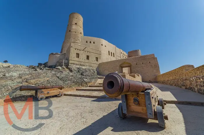 View of Bahla Fort’s towering mud-brick walls and defensive towers under a clear sky in Bahla (Wilayat), Ad Dakhiliyah Governorate