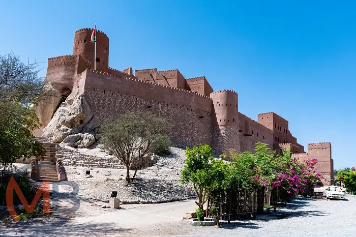 Nakhal Fort: a majestic fortress perched on a rocky hill in Wilayat Nakhal (District), Al Batinah South Governorate, surrounded by lush date palm groves and the Al Hajar Mountains