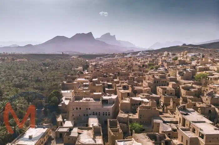 Traditional mud-brick houses of Al Hamra with date palms and rugged mountains in the background, Al Hamra (Wilayat), Ad Dakhiliyah Governorate
